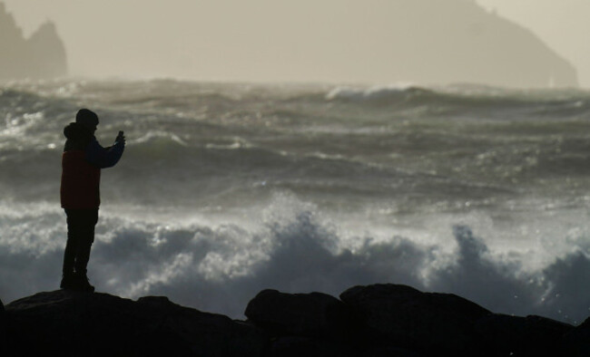 a-person-watching-high-waves-in-doolin-in-county-clare-on-the-west-coast-of-ireland-as-storm-elin-and-storm-fergus-will-bring-gale-force-winds-to-parts-of-ireland-as-met-eireann-issued-a-range-of-weat