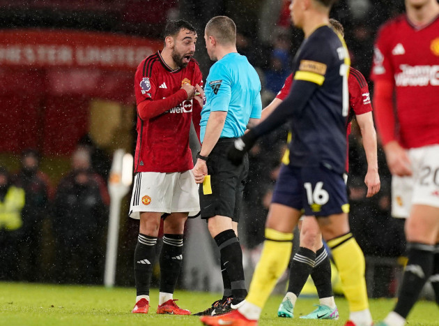manchester-uk-9th-dec-2023-bruno-fernandes-of-manchester-united-l-speaks-to-referee-peter-banks-after-getting-yellow-card-during-the-premier-league-match-at-old-trafford-manchester-picture-cre