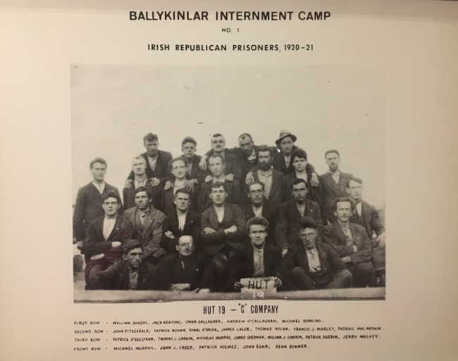Patsy Holmes_Hut 19, 'C' Company, Ballykinlar Camp No. 1, 1921 (Patsy Holmes is holding the sign) Courtesy of Matthew J. Larkin