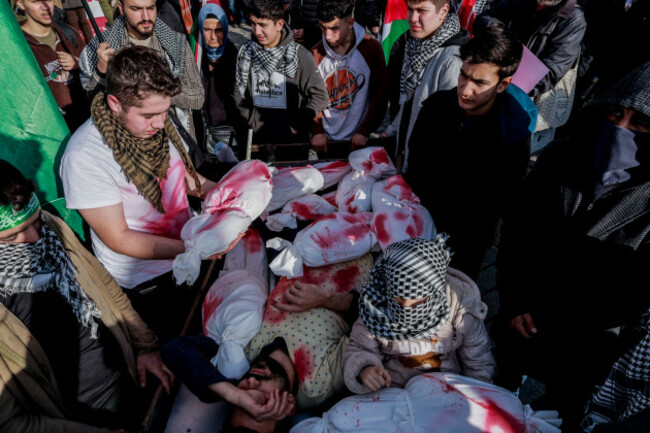 istanbul-turkey-10th-dec-2023-track-youth-use-dolls-wrapped-in-white-sheets-with-stained-fake-blood-in-expression-against-the-killing-of-children-in-gaza-during-a-demonstration-march-several-non