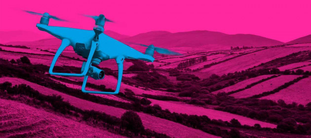 Design for DRONE POLICE - a drone in the foreground is set against a background of Irish fields with hills in the distance.