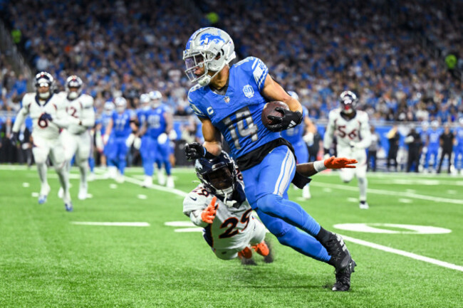 detroit-mi-december-16-denver-broncos-cornerback-jaquan-mcmillian-29-tries-to-wrap-up-detroit-lions-wr-amon-ra-st-brown-14-during-the-game-between-denver-broncos-and-detroit-lions-on-decembe
