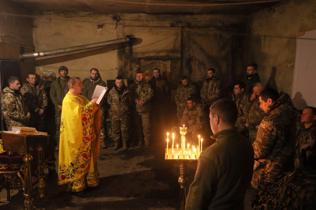chaplain-ivan-of-the-orthodox-church-of-ukraine-reads-a-prayer-for-ukrainian-servicemen-of-the-72nd-mechanized-brigade-during-the-sacred-liturgy-before-the-upcoming-christmas-at-the-frontline-near-vuh