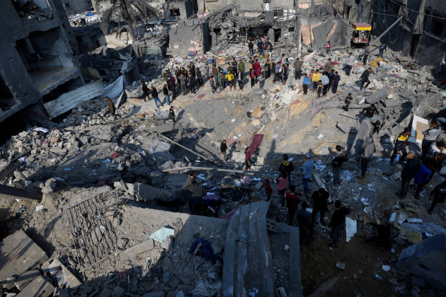 palestinians-look-at-the-destruction-of-the-al-gatshan-family-building-after-an-israeli-strike-in-nusseirat-refugee-camp-central-gaza-strip-monday-dec-18-2023-ap-photoadel-hana