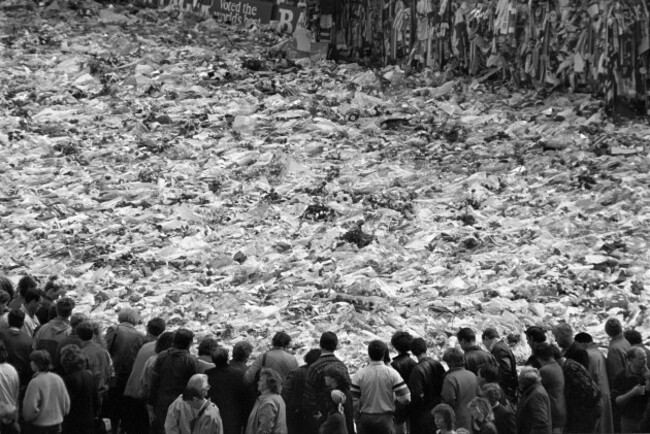 mourners-gather-around-a-sea-of-supporters-scarves-on-the-pitch-at-anfield-liverpool-football-club-after-the-disaster-at-hillsborough-stadium