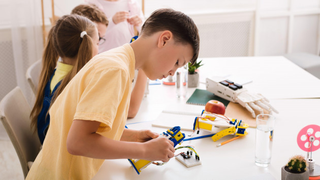 robotic-education-smart-teen-boy-constructing-diy-robot