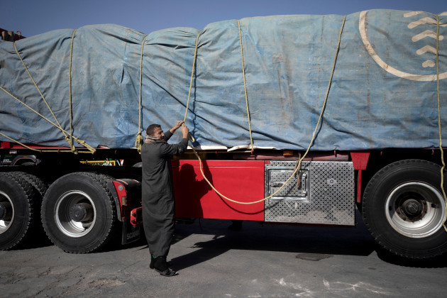 an-egyptian-truck-driver-carrying-humanitarian-aid-for-the-gaza-strip-unties-his-cargo-for-inspection-at-the-kerem-shalom-crossing-in-southern-israel-friday-dec-22-2023-ap-photomaya-alleruzzo