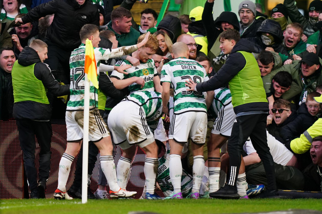 celtics-paulo-bernardo-on-floor-celebrates-with-team-mates-after-scoring-their-sides-first-goal-of-the-game-during-the-cinch-premiership-match-at-celtic-park-glasgow-picture-date-saturday-decem