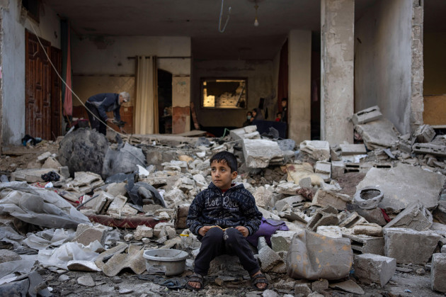 a-palestinian-boy-sits-on-the-rubble-of-a-destroyed-building-after-an-israeli-strike-in-rafah-southern-gaza-strip-friday-dec-29-2023-ap-photofatima-shbair