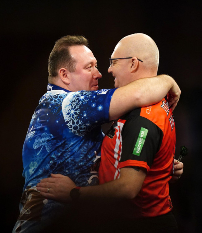 brendan-dolan-reacts-after-his-match-against-mickey-mansell-right-on-day-eight-of-the-paddy-power-world-darts-championship-at-alexandra-palace-london-picture-date-friday-december-22-2023