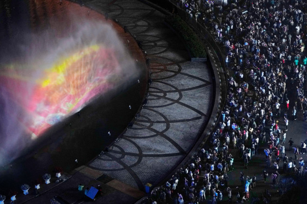 people-gather-to-watch-a-water-screen-fountain-in-the-main-business-district-ahead-the-new-years-eve-in-jakarta-indonesia-sunday-dec-31-2023-ap-photoachmad-ibrahim