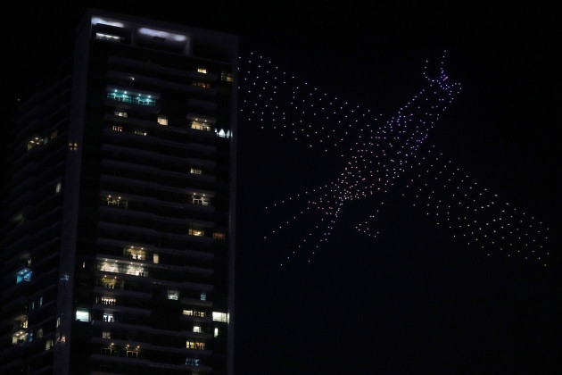 a-light-show-with-drones-in-the-sky-is-performed-above-thousands-of-people-celebrating-the-new-year-in-the-main-business-district-on-new-years-eve-in-jakarta-indonesia-monday-jan-1-2024-ap-pho