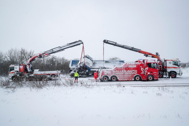rescuers-try-to-recover-a-truck-which-slided-off-road-during-a-heavy-snowfall-in-viborg-central-jutland-denmark-wednesday-jan-3-2024-temperatures-have-fallen-below-minus-40-degrees-celsius-in-th