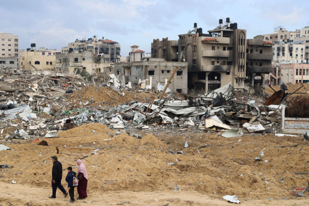 palestinians-walk-past-the-building-destroyed-in-the-israeli-bombardment-of-the-gaza-strip-in-gaza-city-on-wednesday-jan-3-2024-ap-photomohammed-hajjar