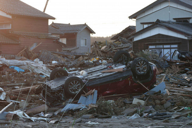 houses-and-a-car-are-damaged-by-an-earthquake-and-tsunami-in-suzu-ishikawa-prefecture-on-jan-2nd-2024-the-yomiuri-shimbun-via-ap-images