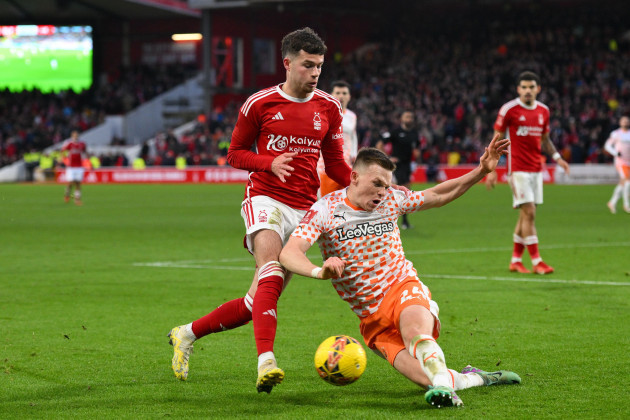 neco-williams-of-nottingham-forest-battles-with-andy-lyons-of-blackpool-during-the-fa-cup-third-round-match-between-nottingham-forest-and-blackpool-at-the-city-ground-nottingham-on-sunday-7th-january