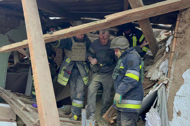 in-this-photo-provided-by-the-ukrainian-emergency-service-emergency-workers-help-a-wounded-man-after-a-residential-houses-were-badly-damaged-in-a-russian-missile-attack-near-kryvyi-rih-ukraine-mon