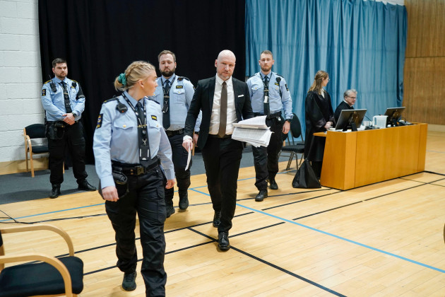 anders-behring-breivik-is-accompanied-by-guards-as-he-arrives-at-the-courtroom-to-give-his-statement-on-day-two-of-the-trial-where-the-oslo-district-court-hears-the-case-concerning-breiviks-prison-t