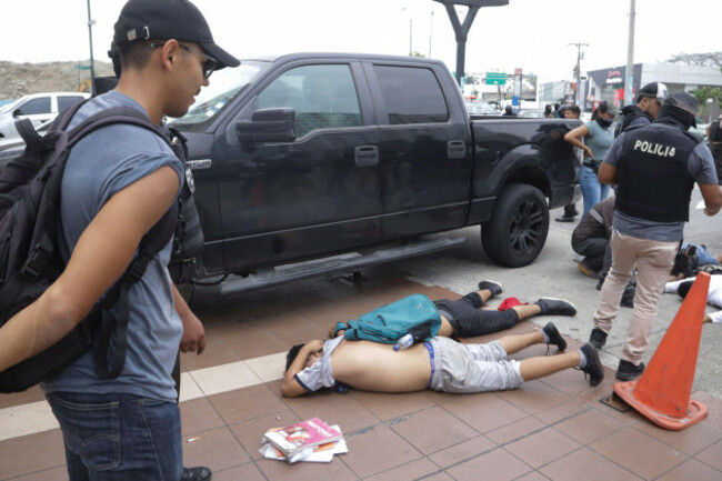 men-lie-face-down-on-the-ground-detained-by-police-outside-tc-television-after-a-producer-told-police-that-they-were-part-of-a-group-who-broke-onto-their-set-during-a-live-broadcast-although-they-h