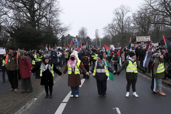 protestors-hold-hands-and-signs-as-they-march-during-a-demonstration-outside-the-international-court-of-justice-in-the-hague-netherlands-thursday-jan-11-2024-the-united-nations-top-court-opens