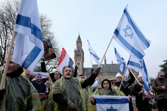 protestors-wave-israeli-flags-and-hold-photos-of-the-hostages-kidnapped-during-the-oct-7-hamas-cross-border-attack-in-israel-during-a-demonstration-outside-the-international-court-of-justice-in-the