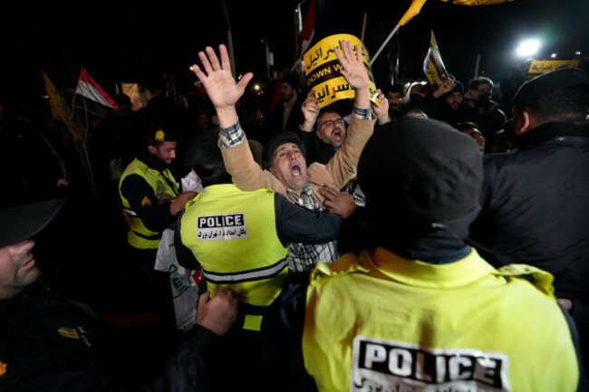 iranian-demonstrators-chant-slogans-as-police-officers-prevent-the-from-approaching-to-the-british-embassy-during-a-protest-against-the-u-s-and-british-military-strike-against-iranian-backed-houthis