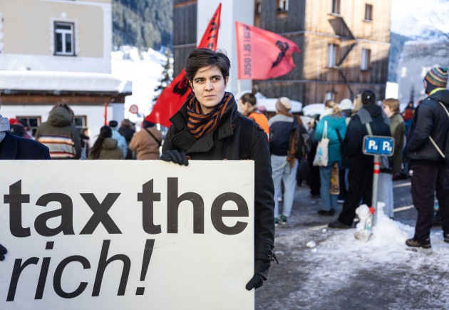 14-january-2024-switzerland-davos-german-austrian-millionaire-heiress-and-social-activist-marlene-engelhorn-holds-a-sign-reading-tax-the-rich-during-a-rally-hundreds-of-people-demonstrated-for
