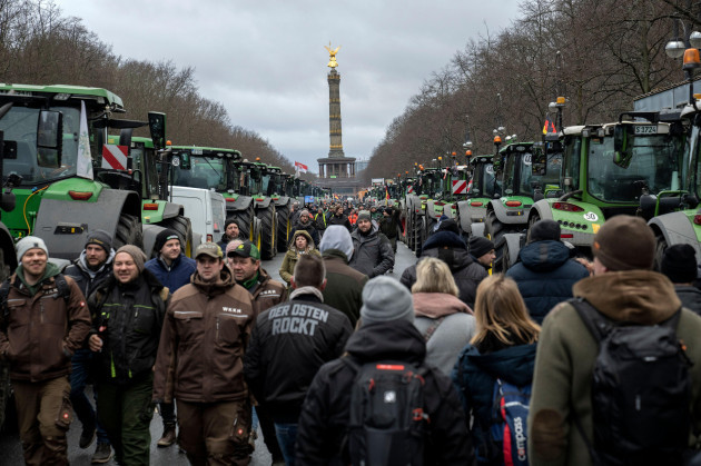 farmers-walk-between-tractors-as-they-arrive-for-a-protest-in-berlin-germany-monday-jan-15-2024-farmers-drove-thousands-of-tractors-into-berlin-on-monday-in-the-climax-of-a-week-of-demonstration
