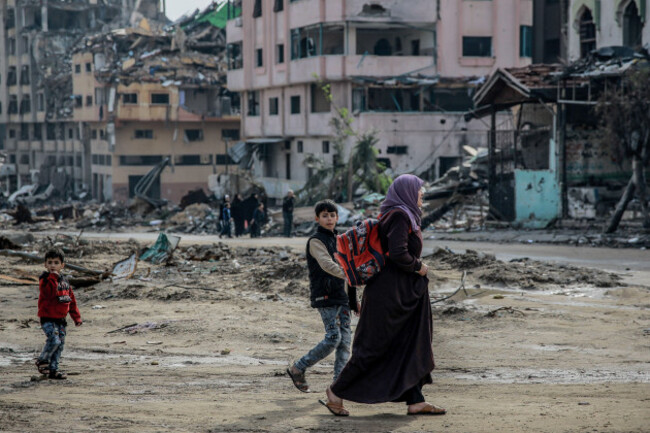 gaza-city-palestinian-territories-15th-jan-2024-a-palestinian-woman-walks-with-children-across-the-destroyed-sheikh-radwan-neighbourhood-in-gaza-city-after-one-hundred-days-of-the-isarel-hamas-wa