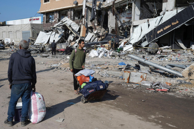 palestinians-walk-through-destruction-by-the-israeli-bombardment-in-the-nusseirat-refugee-camp-in-gaza-strip-tuesday-jan-16-2024-ap-photoadel-hana