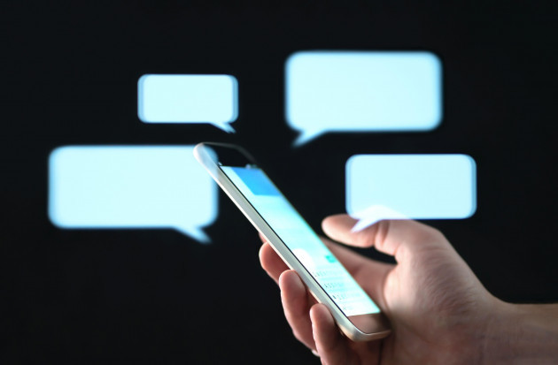 text-messages-in-cellphone-screen-with-abstract-hologram-speech-bubbles-instant-messaging-app-texting-group-chat-sexting-or-sms-concept