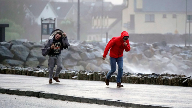 people-walking-in-high-winds-at-salthill-galway-during-storm-isha-a-status-red-wind-warning-has-been-issued-for-counties-donegal-galway-and-mayo-as-authorities-warn-people-to-take-care-ahead-of-st