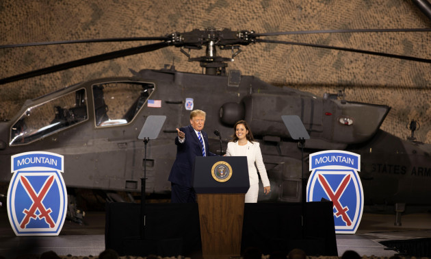 u-s-president-donald-trump-introduces-congresswoman-elise-stefanik-to-soldiers-from-the-10th-mountain-division-from-in-front-of-an-apache-attack-helicopter-during-a-visit-to-sign-the-john-mccain-natio