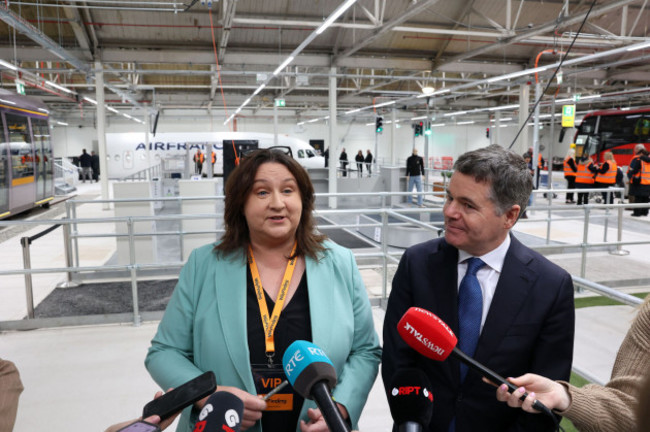 Rabbitte and Donohoe speaking to the press whose microphones are in the shot.