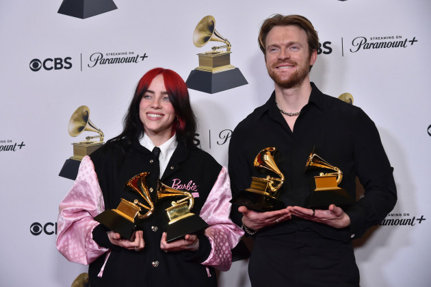 billie-eilish-left-and-finneas-pose-in-the-press-room-with-the-awards-for-best-song-written-for-visual-media-and-song-of-the-year-for-what-was-i-made-for-from-barbie-the-album-during-the-66th-a
