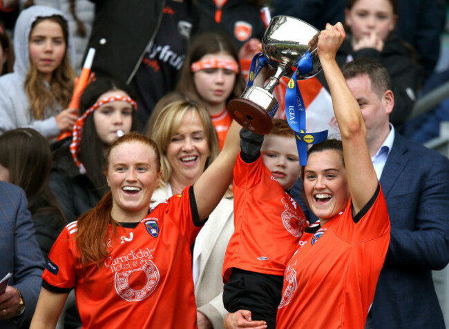blaithin-mackin-and-aimee-mackin-lift-the-lidl-ladies-national-football-league-division-2-cup-with-their-nephew-fionn