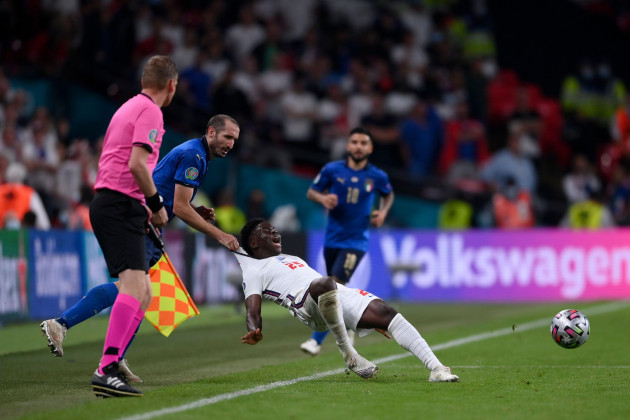 italys-giorgio-chiellini-left-stops-englands-bukayo-saka-during-the-euro-2020-soccer-final-match-between-england-and-italy-at-wembley-stadium-in-london-sunday-july-11-2021-laurence-griffiths