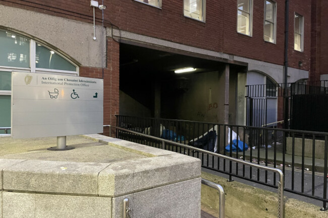 In the foreground a sign reads Office of International Protection, in the background is a tent