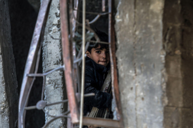 rafah-palestinian-territories-12th-feb-2024-a-palestinian-child-inspects-damaged-buildings-after-israeli-airstrikes-on-rafah-southern-gaza-strip-credit-abed-rahim-khatibdpaalamy-live-news