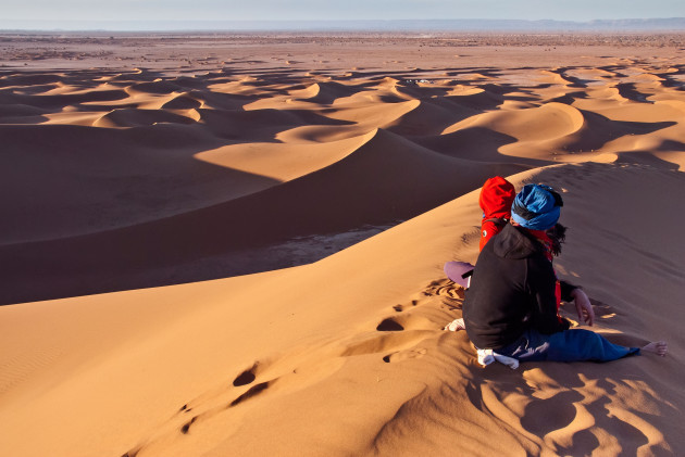 trekkers-rest-on-a-sand-dune-in-the-western-sahara