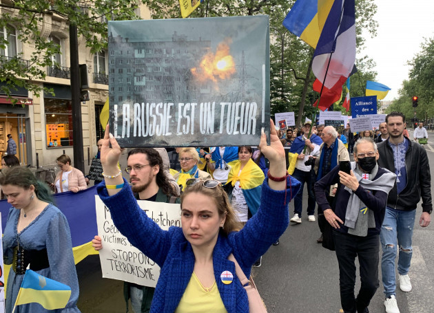 paris-france-06th-may-2023-protestors-hold-ukrainian-flags-during-a-rally-in-protest-against-russias-invasion-of-ukraine-saturday-may-6-2023-in-paris-ukrainians-living-in-france-regularly-tur