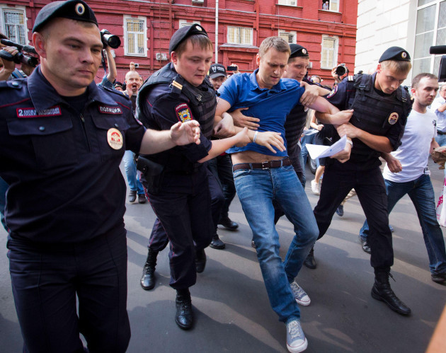 file-police-officers-detain-russian-opposition-leader-alexei-navalny-center-in-moscow-russia-on-wednesday-july-10-2013-ap-photoevgeny-feldman-file