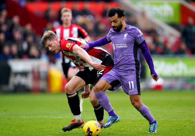 liverpools-mohamed-salah-right-battles-for-the-ball-with-brentfords-nathan-collins-before-going-on-to-score-their-sides-third-goal-of-the-game-during-the-premier-league-match-at-the-gtech-communi
