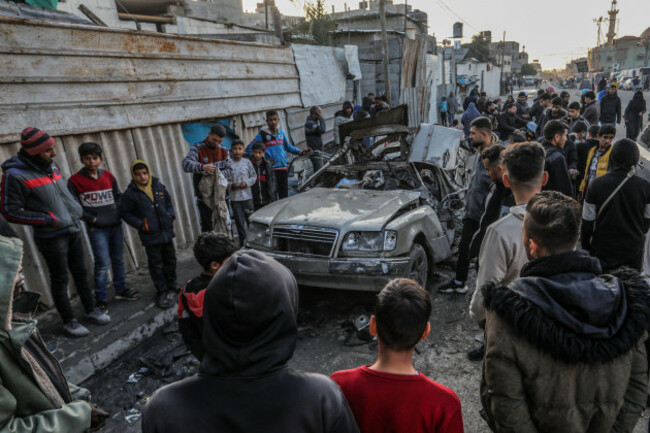 rafah-palestinian-territories-20th-feb-2024-palestinians-inspect-a-vehicle-destroyed-by-an-israeli-military-drone-where-two-persons-were-killed-and-others-injured-according-to-the-gaza-ministry