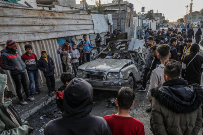 rafah-palestinian-territories-20th-feb-2024-palestinians-inspect-a-vehicle-destroyed-by-an-israeli-military-drone-where-two-persons-were-killed-and-others-injured-according-to-the-gaza-ministry