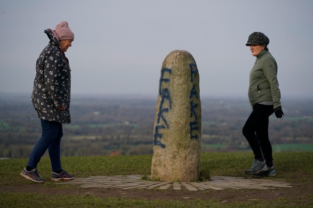 members-of-the-public-look-at-graffiti-on-the-lia-fail-standing-stone-which-is-also-known-as-the-stone-of-destiny-on-the-hill-of-tara-near-skryne-in-county-meath-picture-date-wednesday-february-8