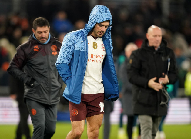 manchester-citys-jack-grealish-looks-dejected-as-he-walks-across-the-pitch-at-half-time-after-being-substituted-through-injury-during-the-emirates-fa-cup-fifth-round-match-at-kenilworth-road-luton