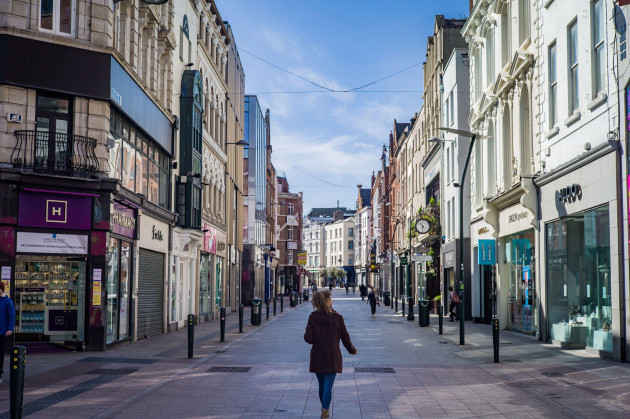 a-woman-walks-alone-along-grafton-st-the-main-shopping-street-in-dublin-during-the-2020-lockdown