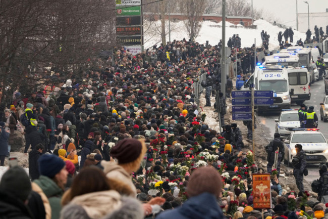 police-right-observe-as-people-walk-towards-the-borisovskoye-cemetery-for-the-funeral-ceremony-of-russian-opposition-leader-alexei-navalny-in-moscow-russia-friday-march-1-2024-under-a-heavy-po