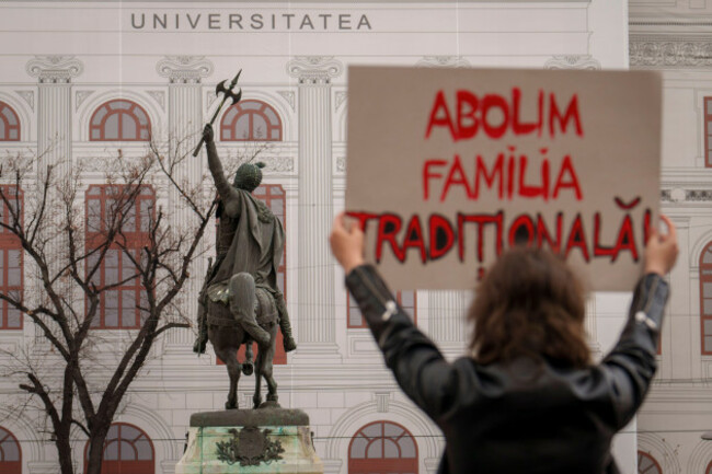 a-woman-holds-a-banner-that-reads-we-abolish-the-traditional-family-a-reference-to-a-term-widely-used-by-romanian-anti-gay-rights-groups-during-a-protest-for-womens-rights-on-international-women